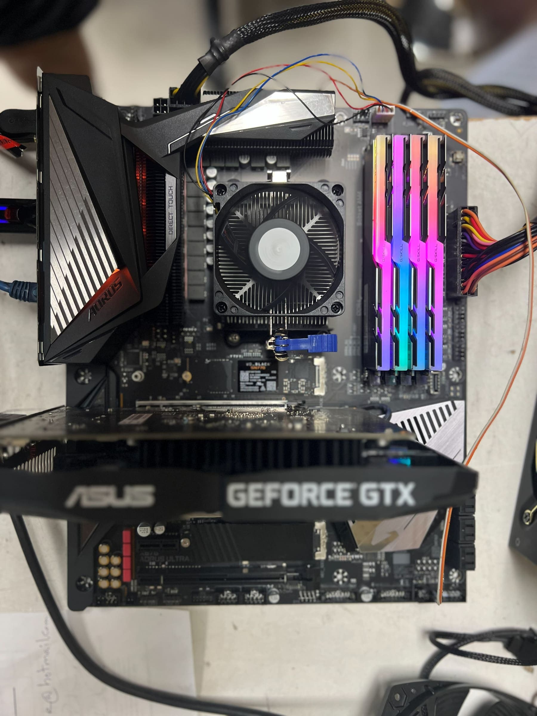 ASUS motherboard with RGB memory and customer-supplied parts at the Technoland bench